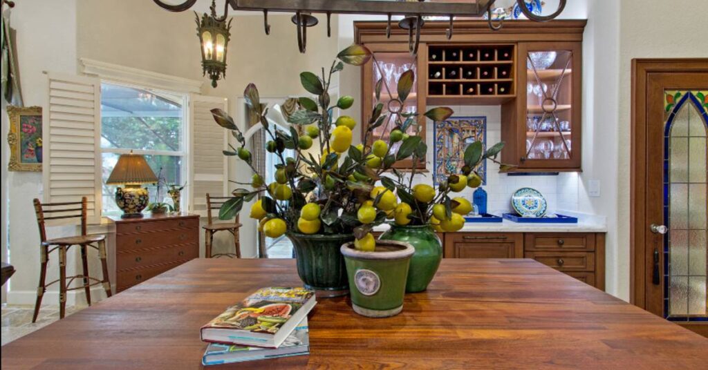 An image of a kitchen and island with a lemon plant and cookbooks.